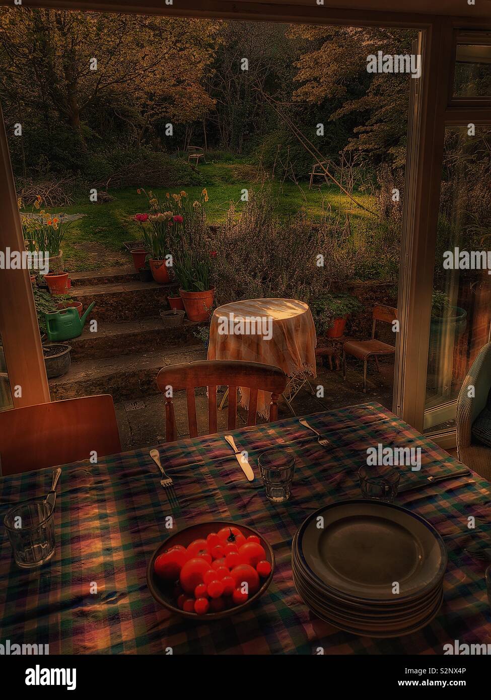 Colpo atmosferica della tabella in prossimità di porte con vista attraverso il giardino - Immagine stock catturata con smartphone