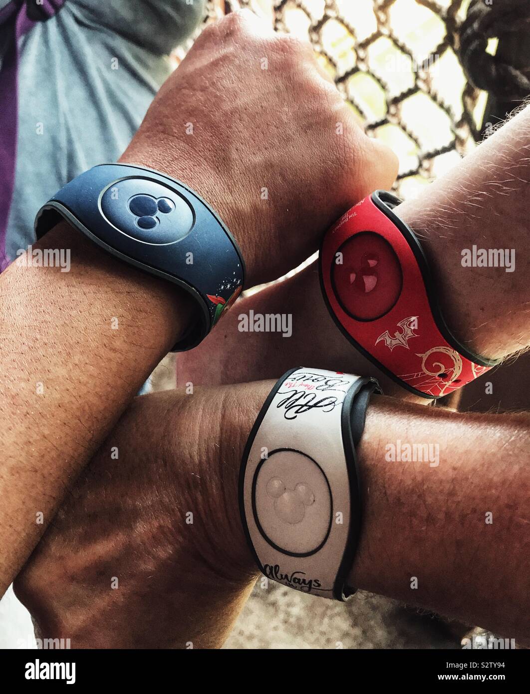 Famiglia con i pugni insieme mostra Disney Magic fascette da polso - Immagine stock catturata con smartphone