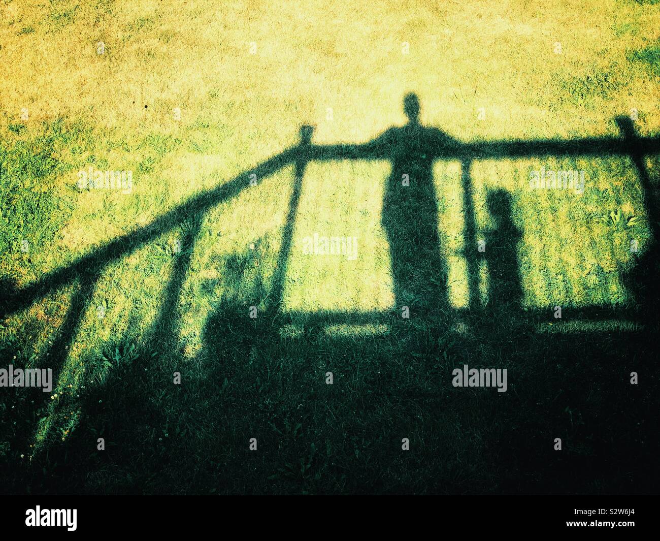 La madre e il bambino ombra sagome di erba da un balcone - Immagine stock catturata con smartphone