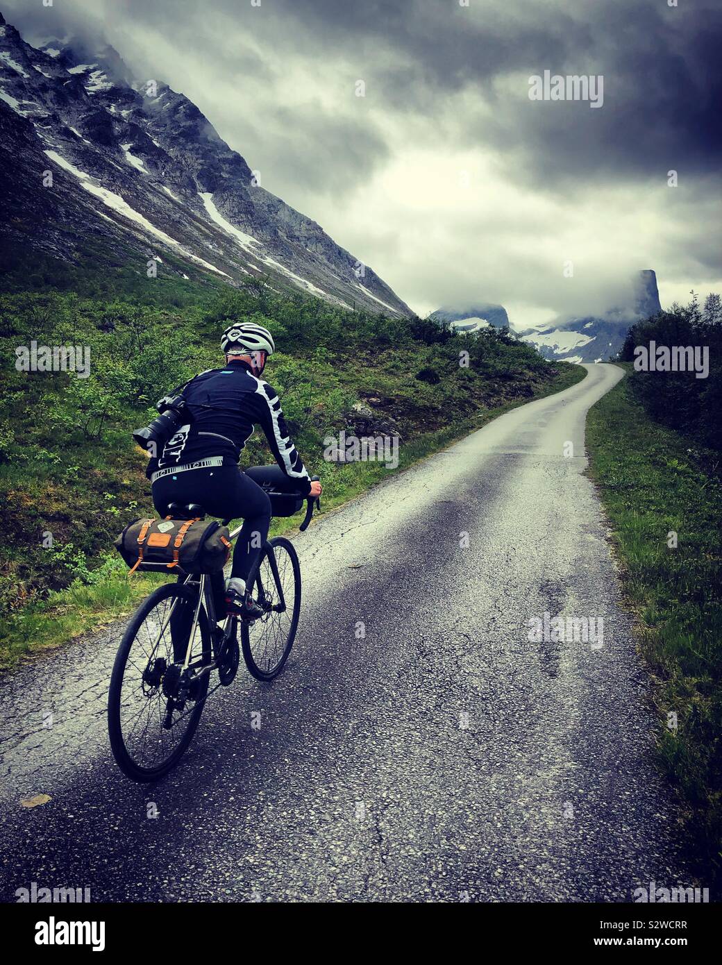 Ciclista maschio nella valle Romsdal, Norvegia Foto Stock