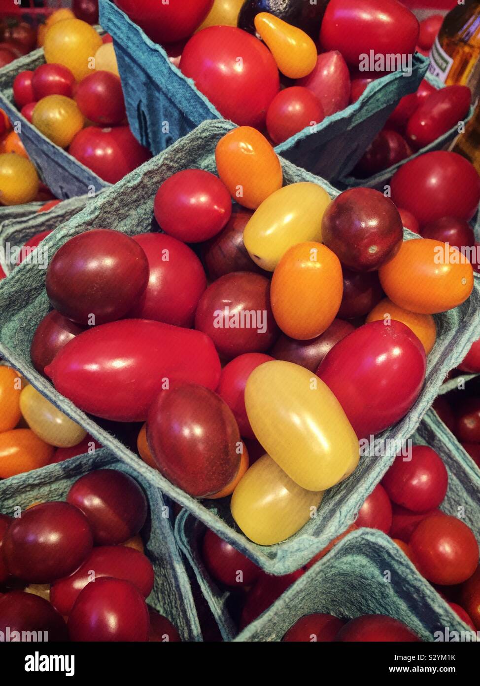 Scatole di cartone di localmente cimelio di pomodori nel produrre del corridoio della drogheria, STATI UNITI D'AMERICA - Immagine stock catturata con smartphone