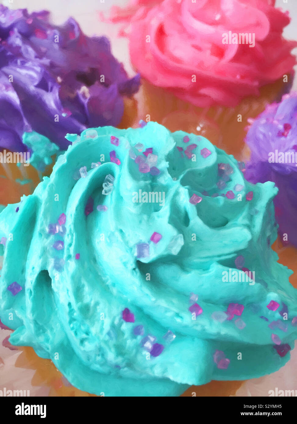 Luminoso e colorato assortimento di crema di burro tortini smerigliato ricoperti di zucchero candito spruzza. Questa immagine ha una texture pittorica di effetto. Foto Stock