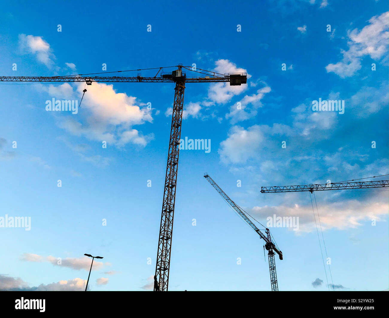 Gru a torre, edificio di costruzione contro il cielo blu Foto Stock