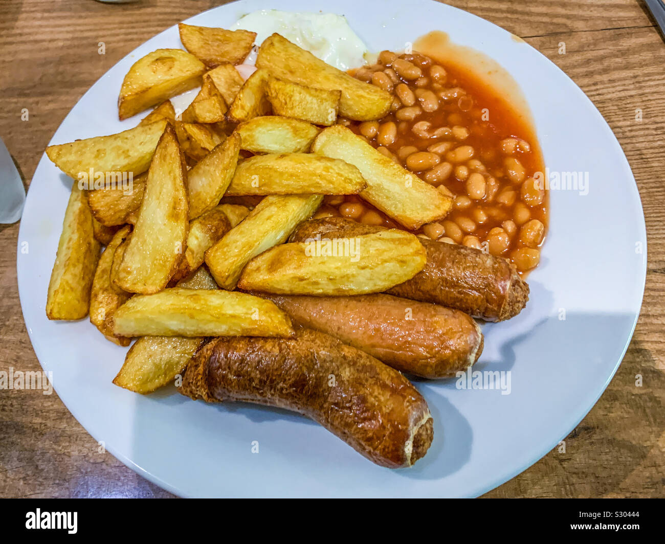 Chip uova salsiccia e fagioli su piastra Foto Stock