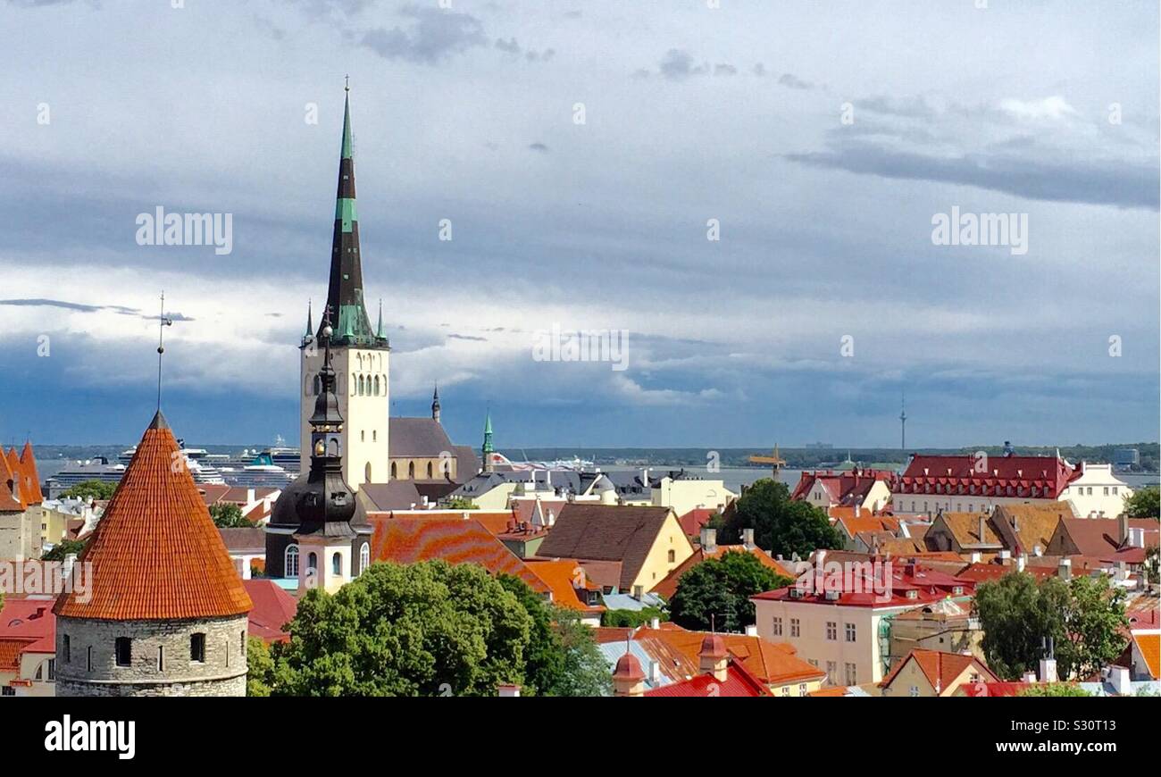 Vista panoramica su tetti in tegole rosse del centro medievale della città vecchia di Tallinn, con la Chiesa di San Olaf. Splendida città vecchia terrazza sul tetto del centro storico di Tallinn, Estonia. Foto Stock