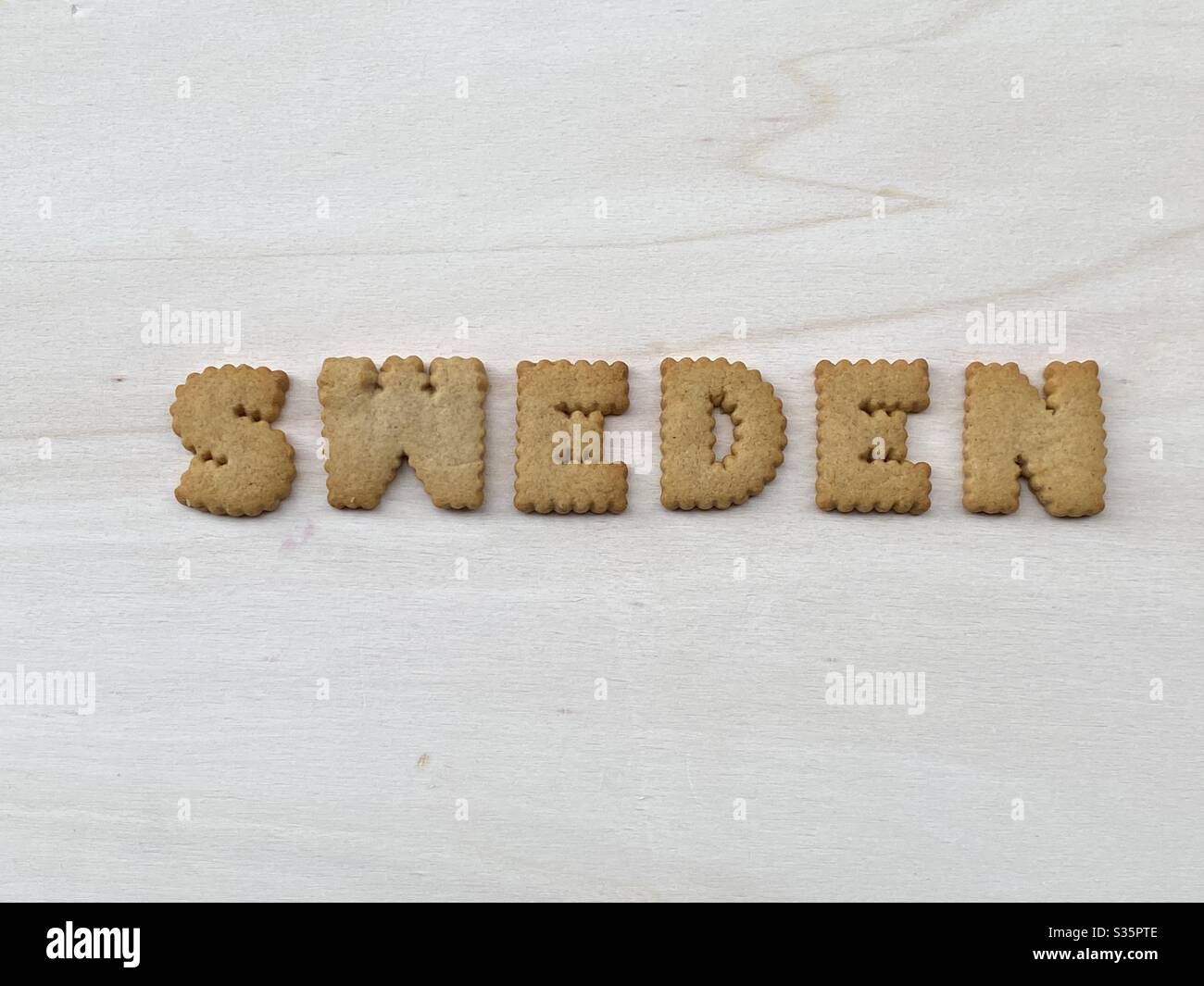 Svezia, paese nordico europeo composto con lettere di biscotto su un bordo di legno bianco Foto Stock