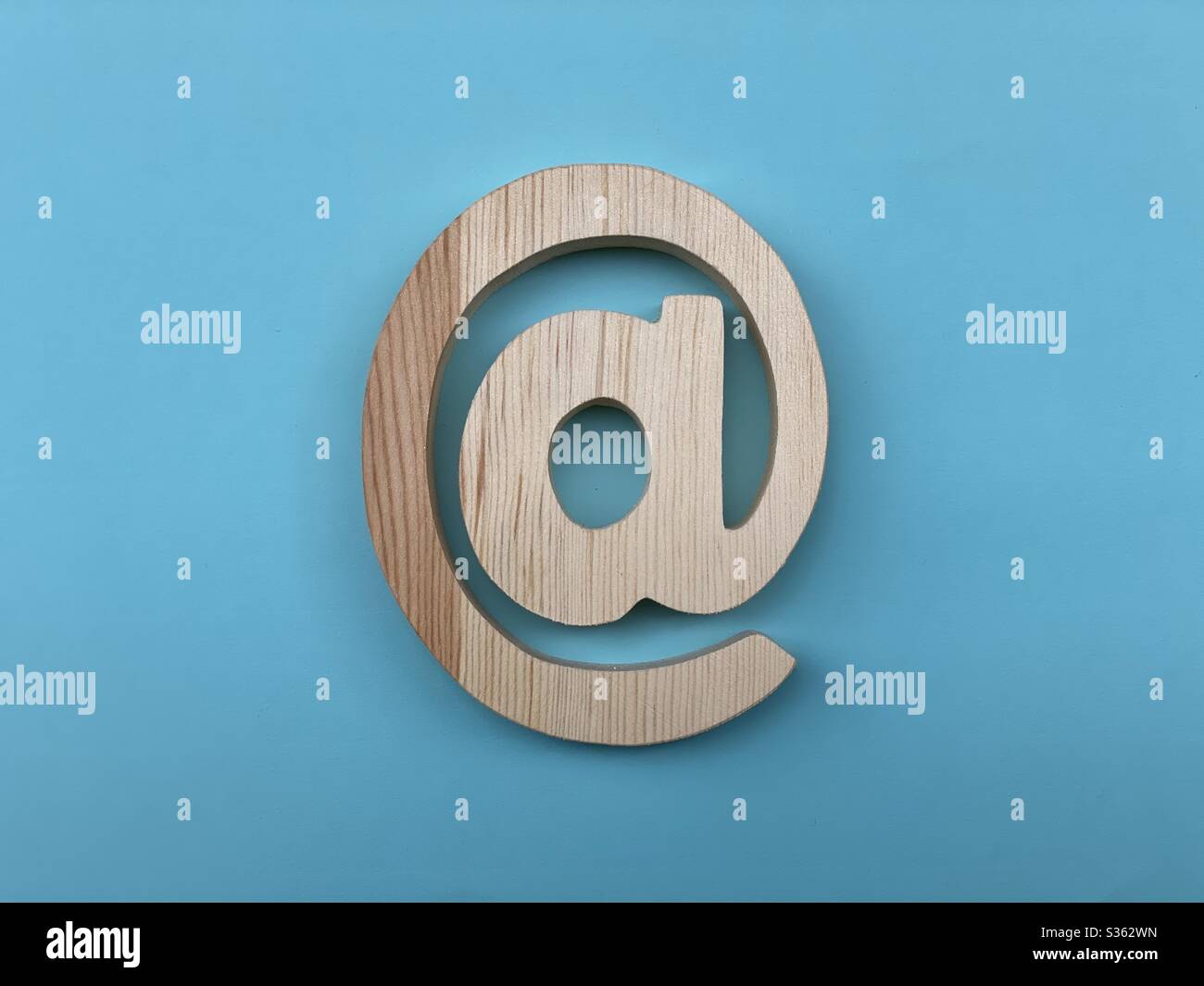 Legno a simbolo e-mail su colore blu - Immagine stock catturata con smartphone