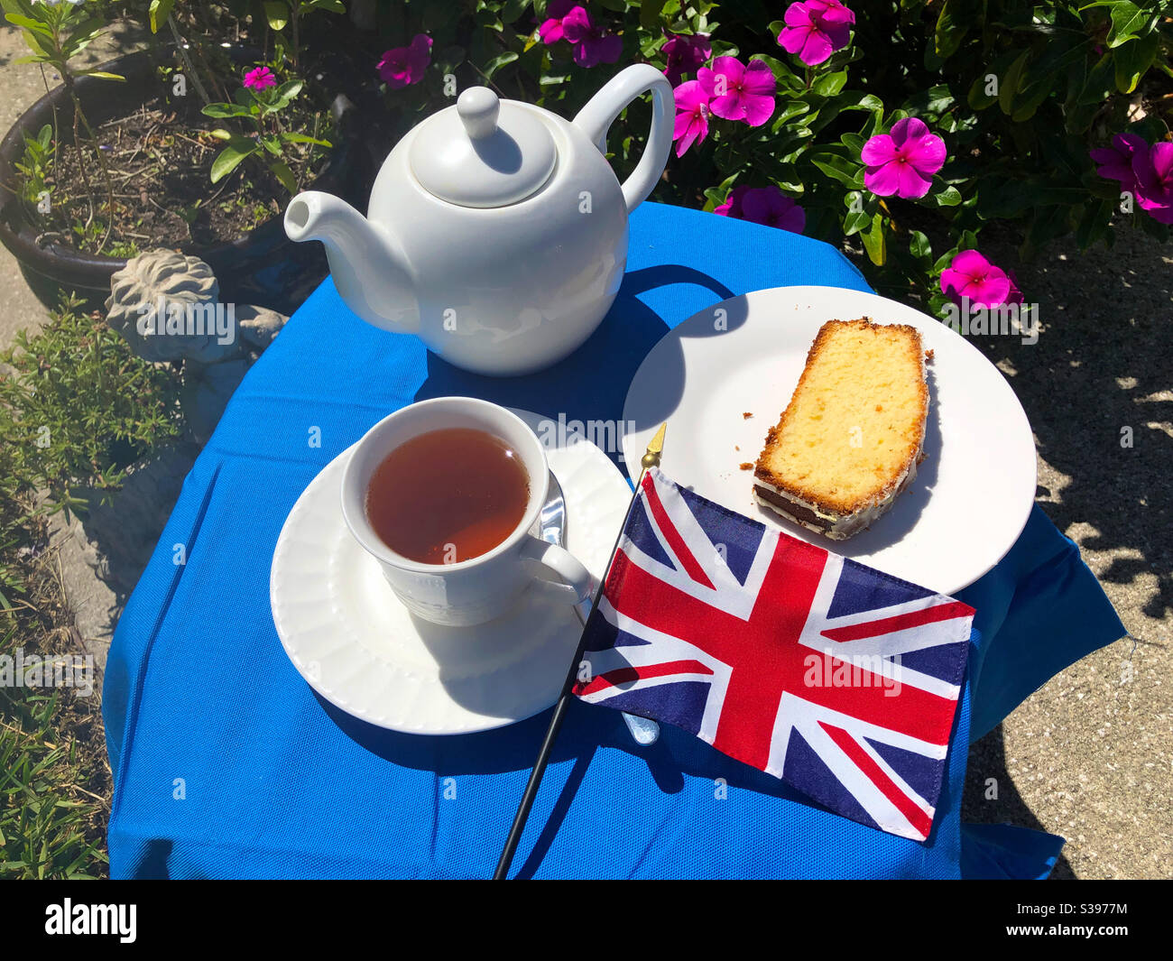 Un piccolo set da tavolo per il tè per uno con torta E il Union Jack - Immagine stock catturata con smartphone