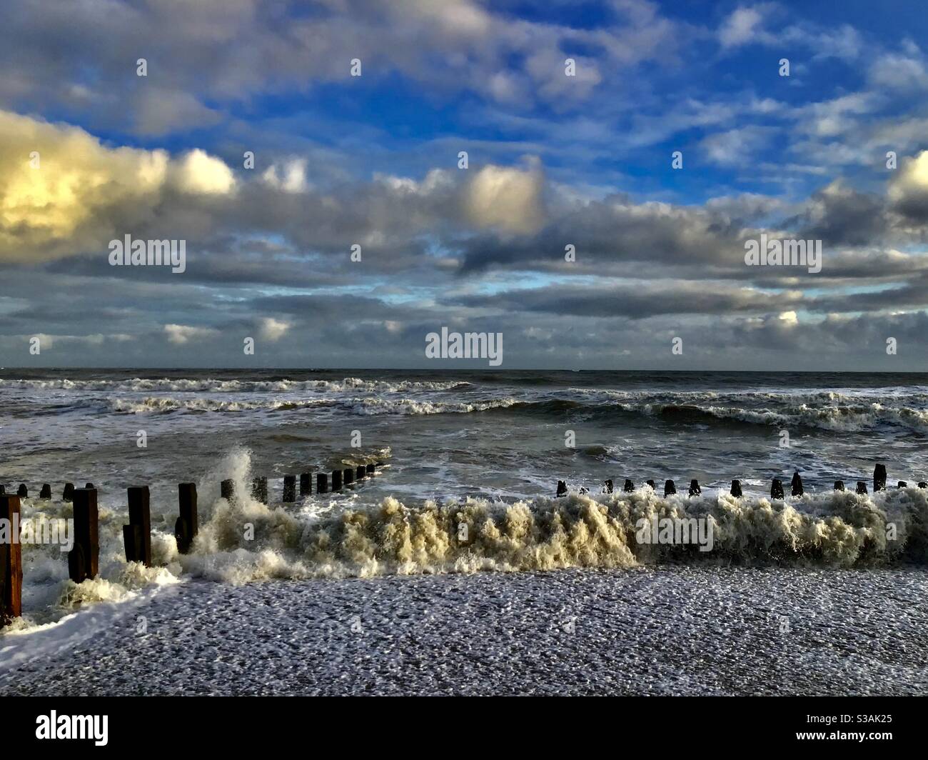 Onde che si infrangono sulla spiaggia Foto Stock