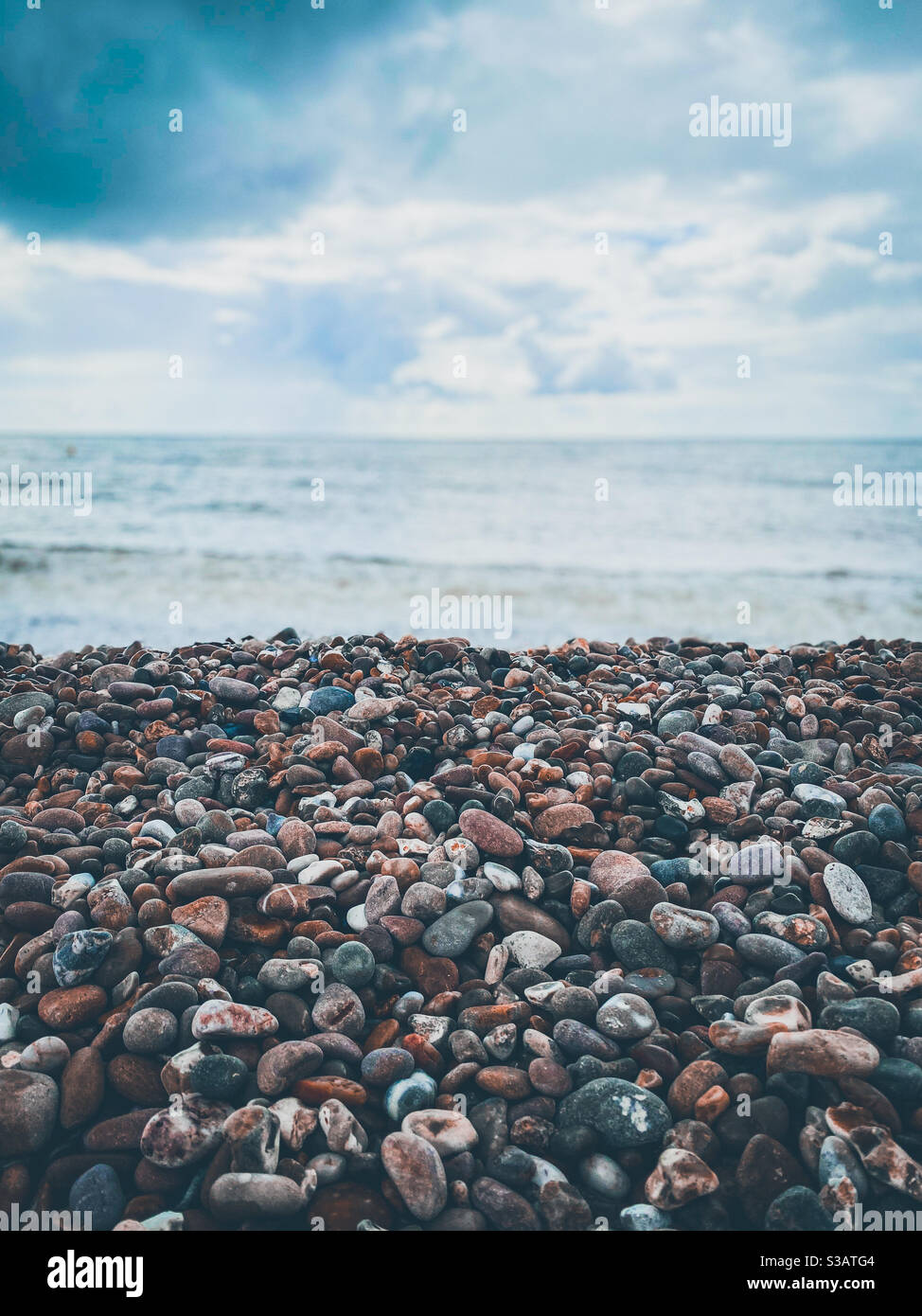 Ciottoli su una spiaggia di pietra vicino al mare. Foto Stock
