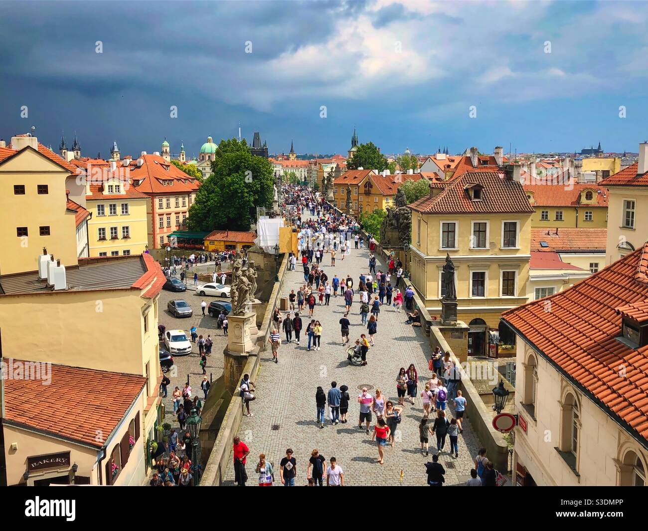 Edifici storici a Praga e il Ponte Carlo medievale pieno di persone, Repubblica Ceca. - Immagine stock catturata con smartphone