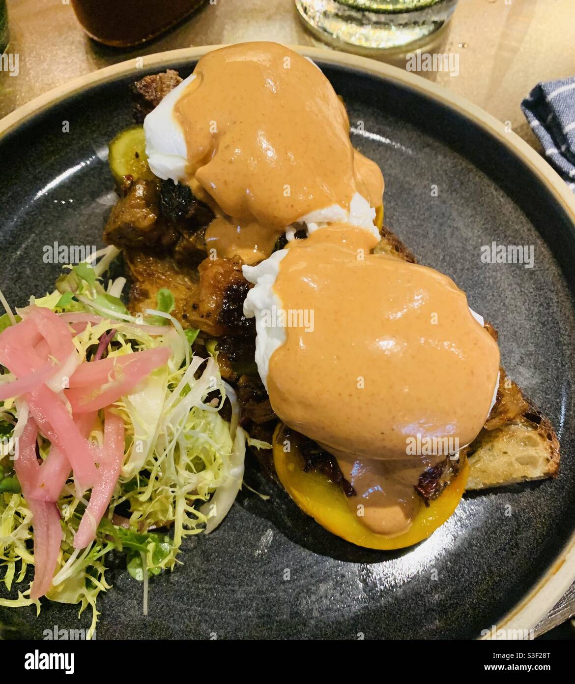 Brisket tirato con uovo in camicia e salsa Hollandaise. Foto Stock