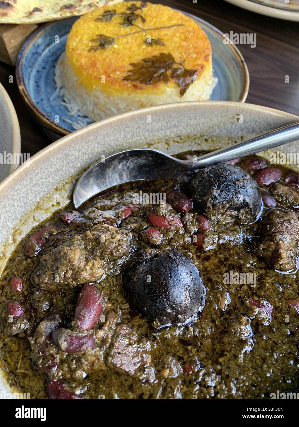 Piatto iraniano gormeh sabzi con tahdig riso croccante Foto Stock