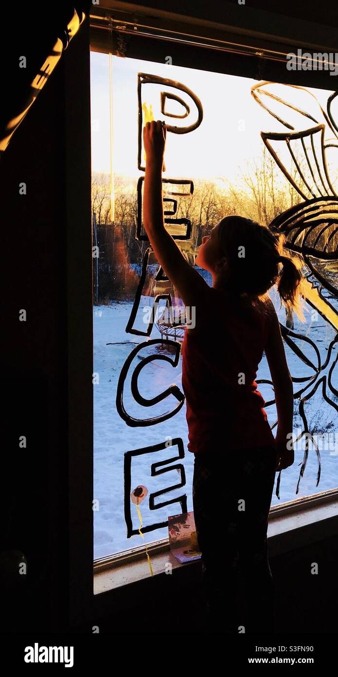 Ragazza che dipinge un messaggio di finestra. Foto Stock