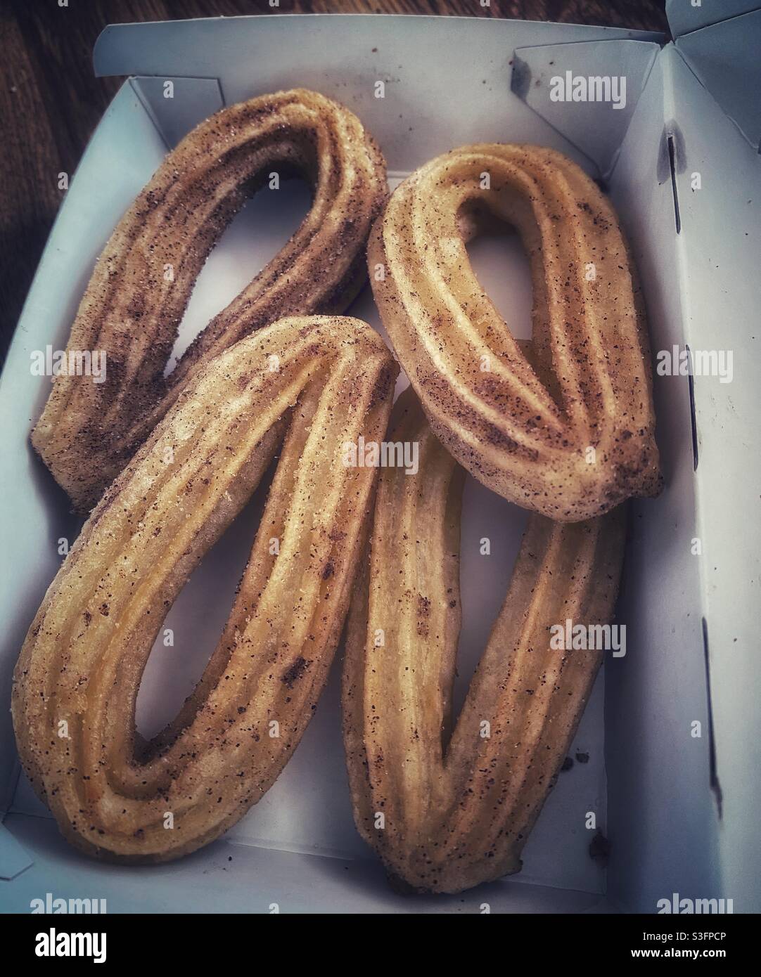 Una fotografia di una scatola di 4 churros Foto Stock