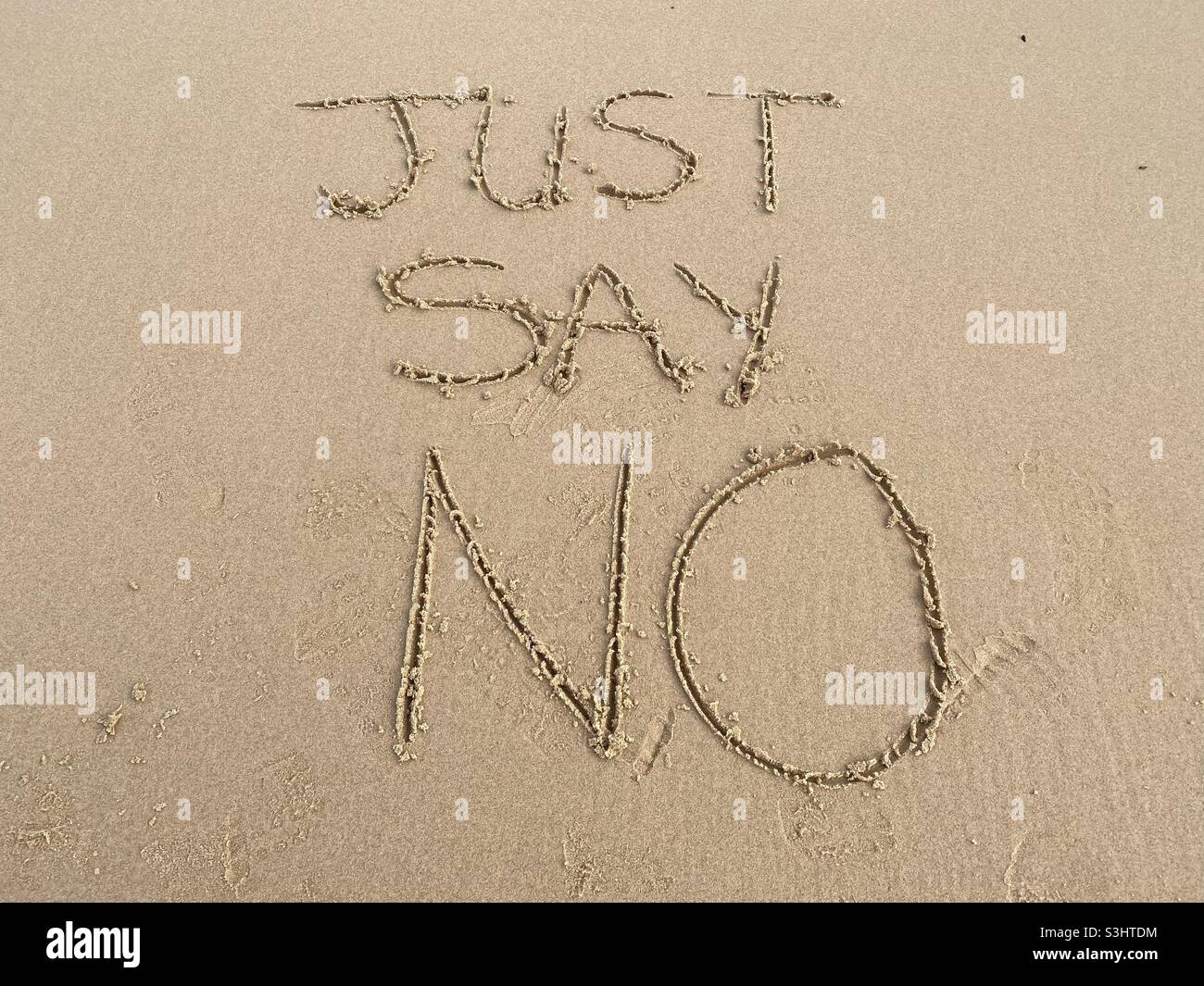 Le parole dicono solo no scritto nella sabbia su una spiaggia Foto Stock