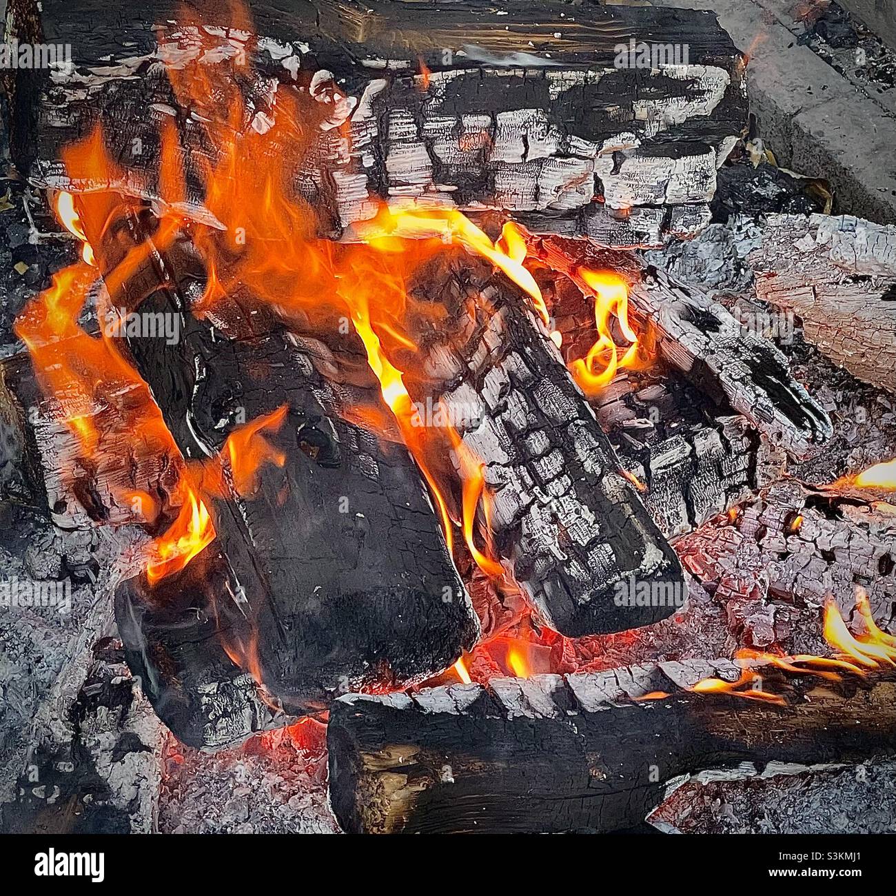 Un incendio brucia in una fossa di un parco locale che tiene una riunione di famiglia nello Utah, USA. - Immagine stock catturata con smartphone