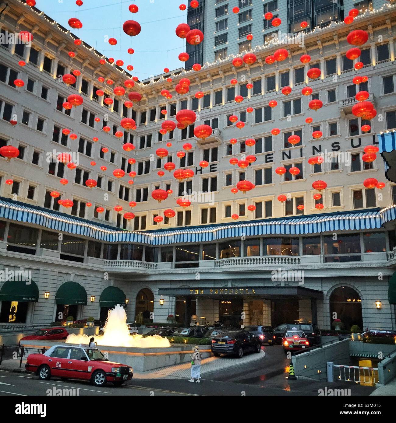 Le lanterne rosse per il Capodanno cinese decorano l'ingresso al Peninsula Hotel, Tsim Sha Tsui, Kowloon, Hong Kong Foto Stock