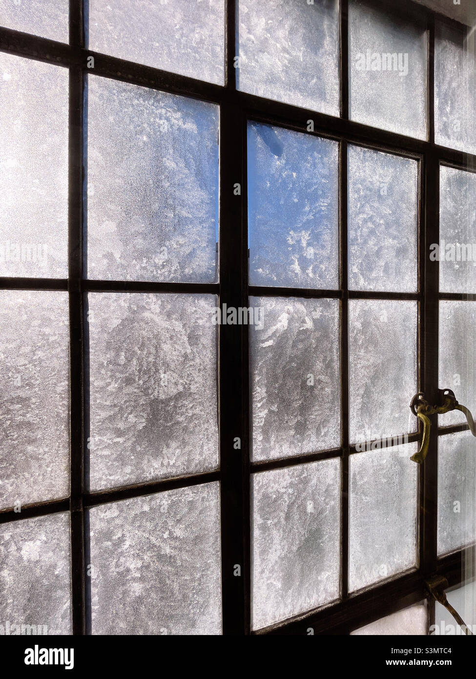Ghiaccio che copre una finestra di casement in un appartamento di New York City durante una tempesta invernale 2022 gennaio, USA - Immagine stock catturata con smartphone