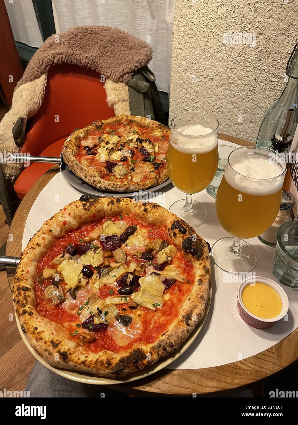 Due pizze e due birre su un tavolo da ristorante a Manchester nel Regno Unito Foto Stock