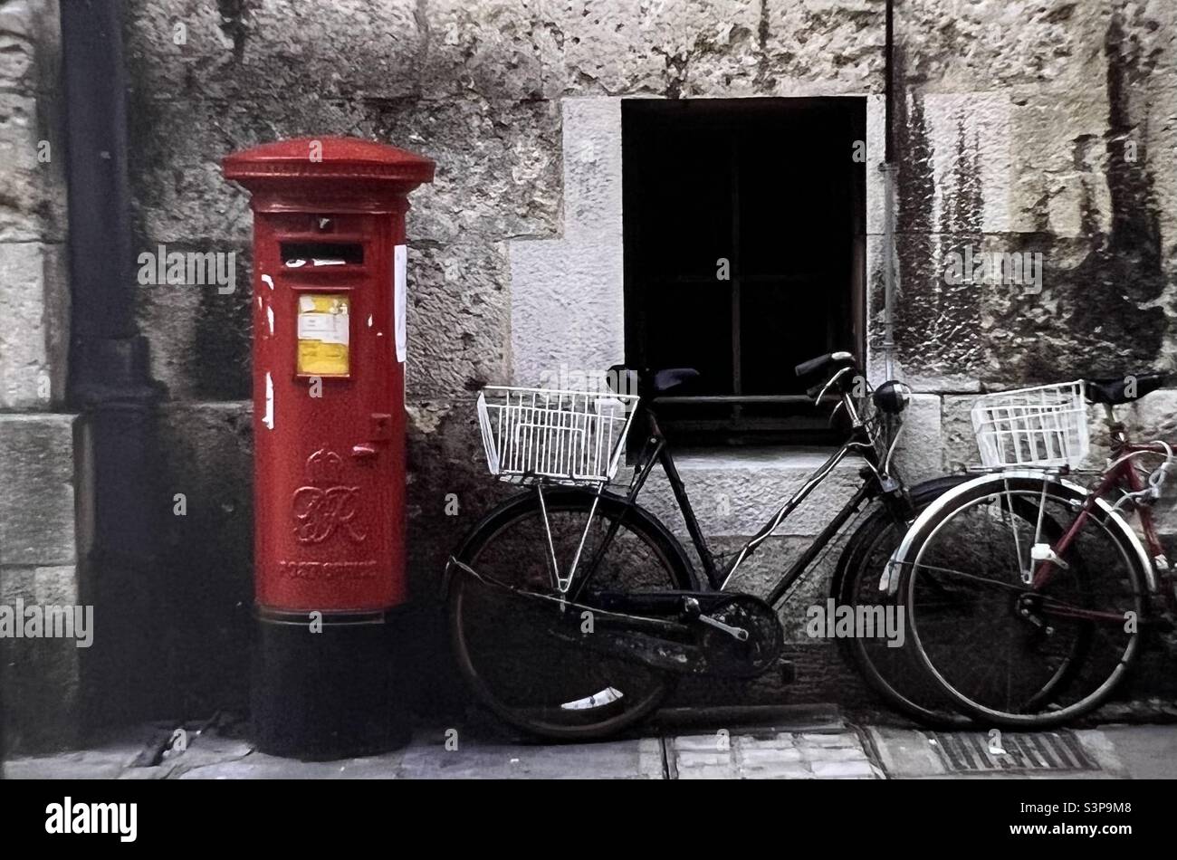 Bicicletta parcheggiata vicino a casella postale Inghilterra Foto Stock