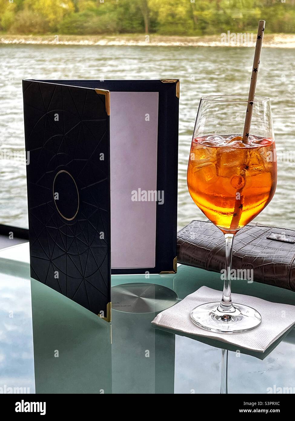 Bicchiere di Aperol Spritz su un tavolo nel salone di una nave da crociera sul fiume Foto Stock