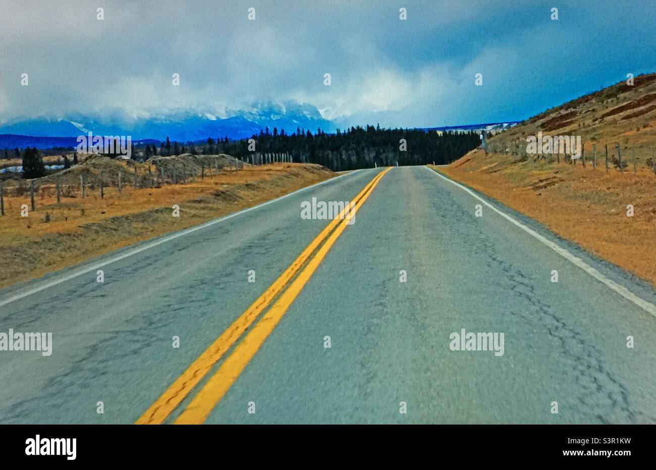 Strada per le Montagne Rocciose, autostrada, marciapiede, linea gialla, linea gialla doppia, Attenzione, nessun passaggio, montagne, linee convergenti, linee diagonali, linee inclinate, inclinate, asintote oblique Foto Stock
