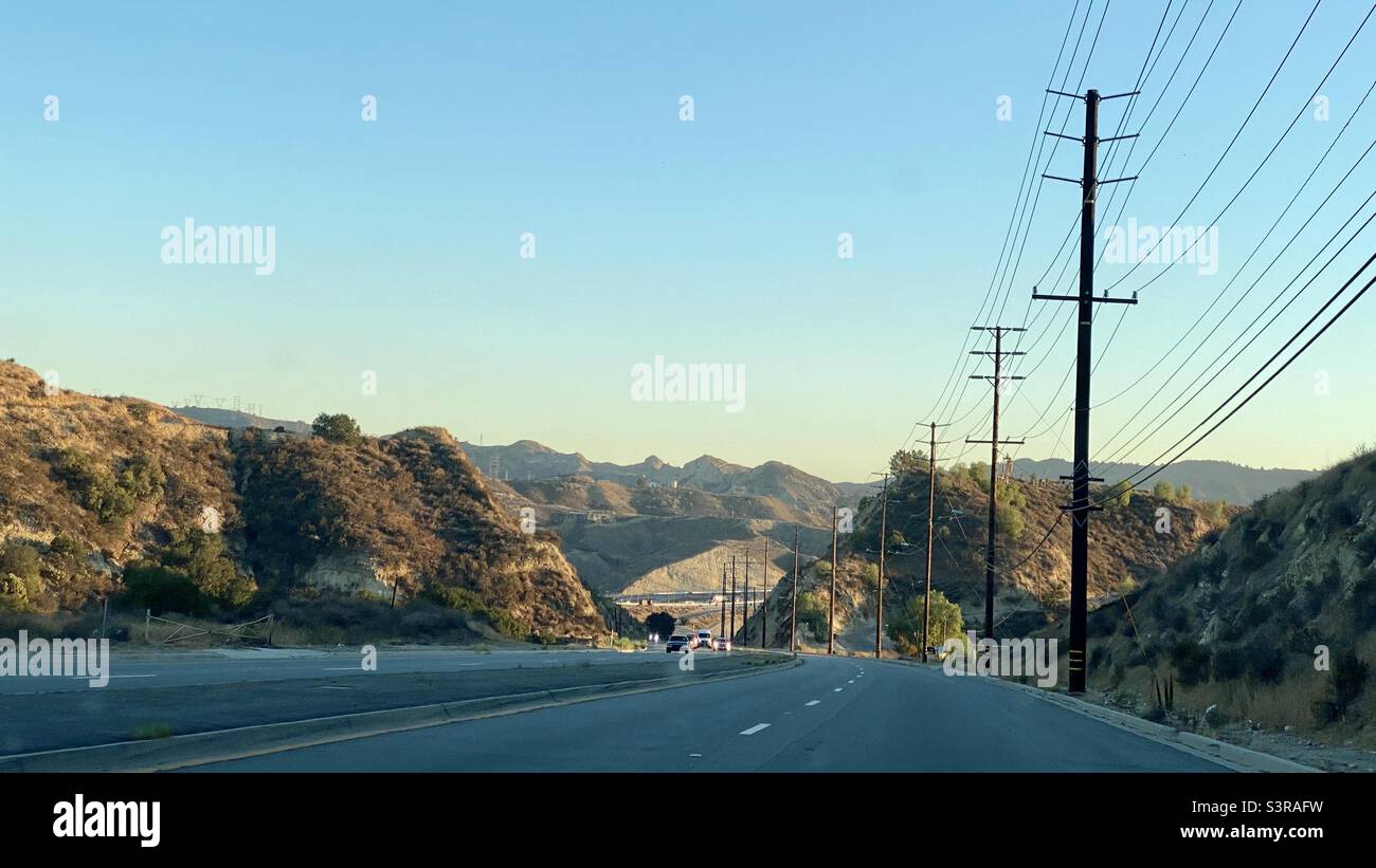 I pali di Telegraph corrono lungo la strada attraverso le montagne a Newhall, Santa Clarita, California Foto Stock
