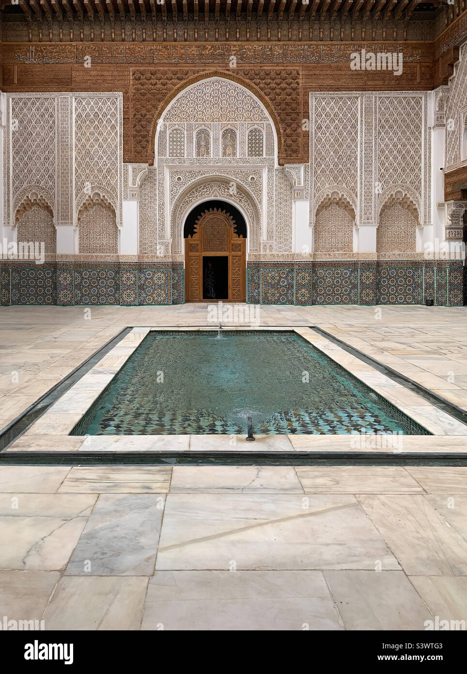 Il cortile principale e la piscina riflettente nella Madrasa ben Youssef, un tempo la più grande scuola islamica del Marocco, Marrakech, Marocco, Nord Africa. Foto Stock