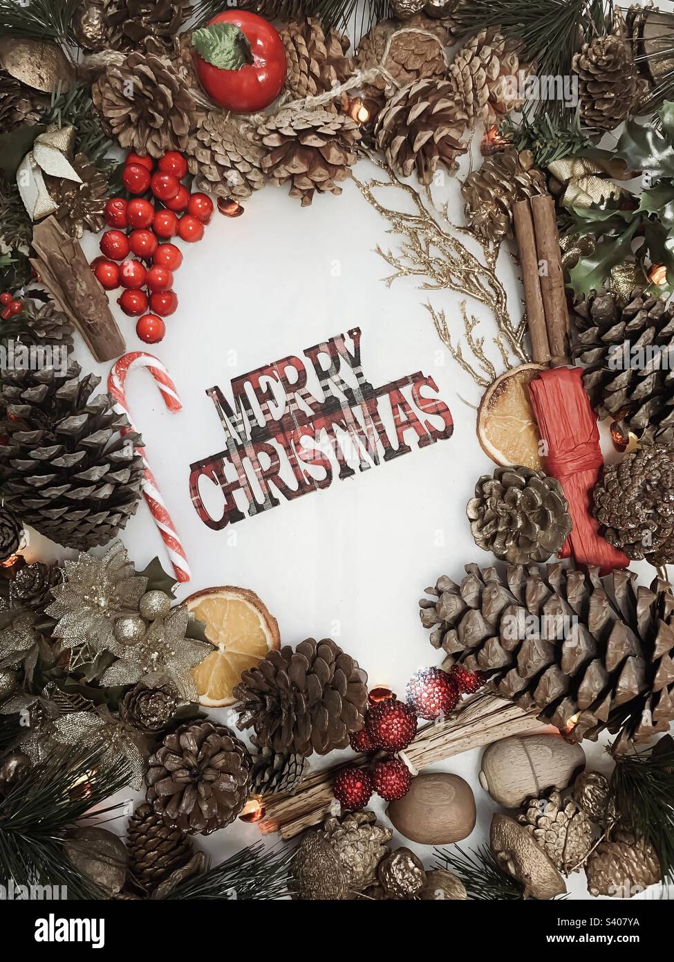 Un espositore festivo intorno a lettere tartan che recita Merry Christmas - Immagine stock catturata con smartphone