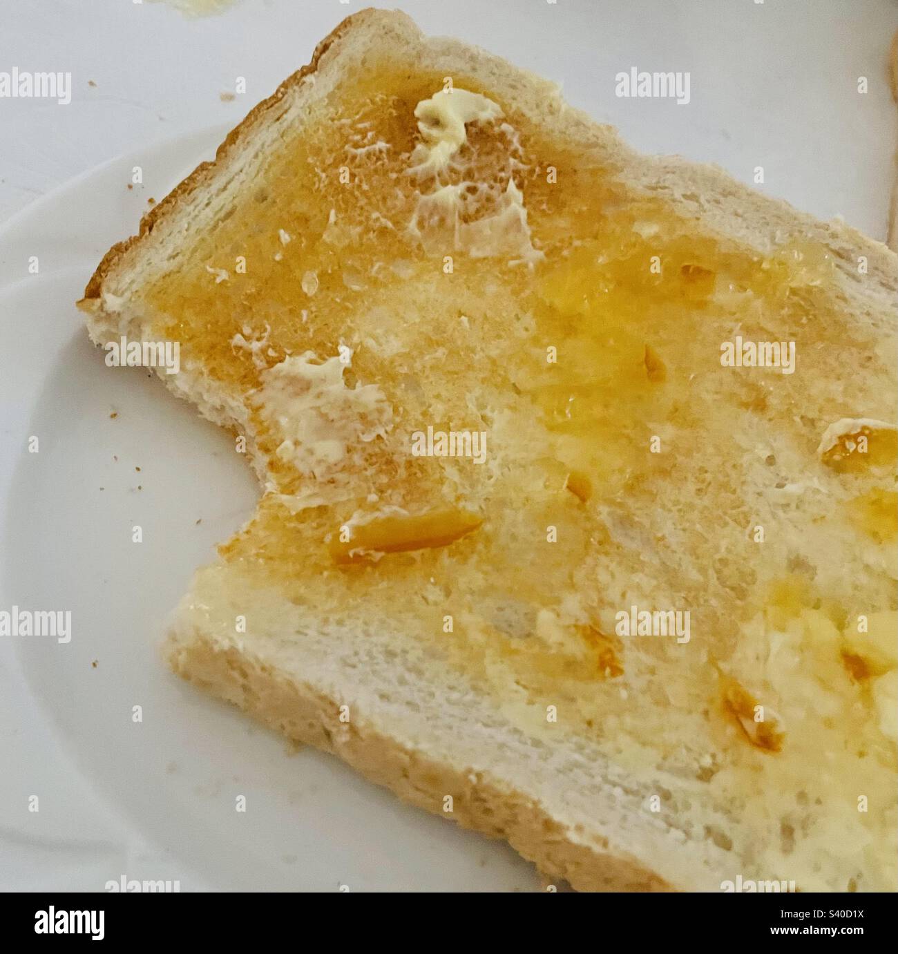 Marmellata d'arancia su pane tostato bianco Foto Stock