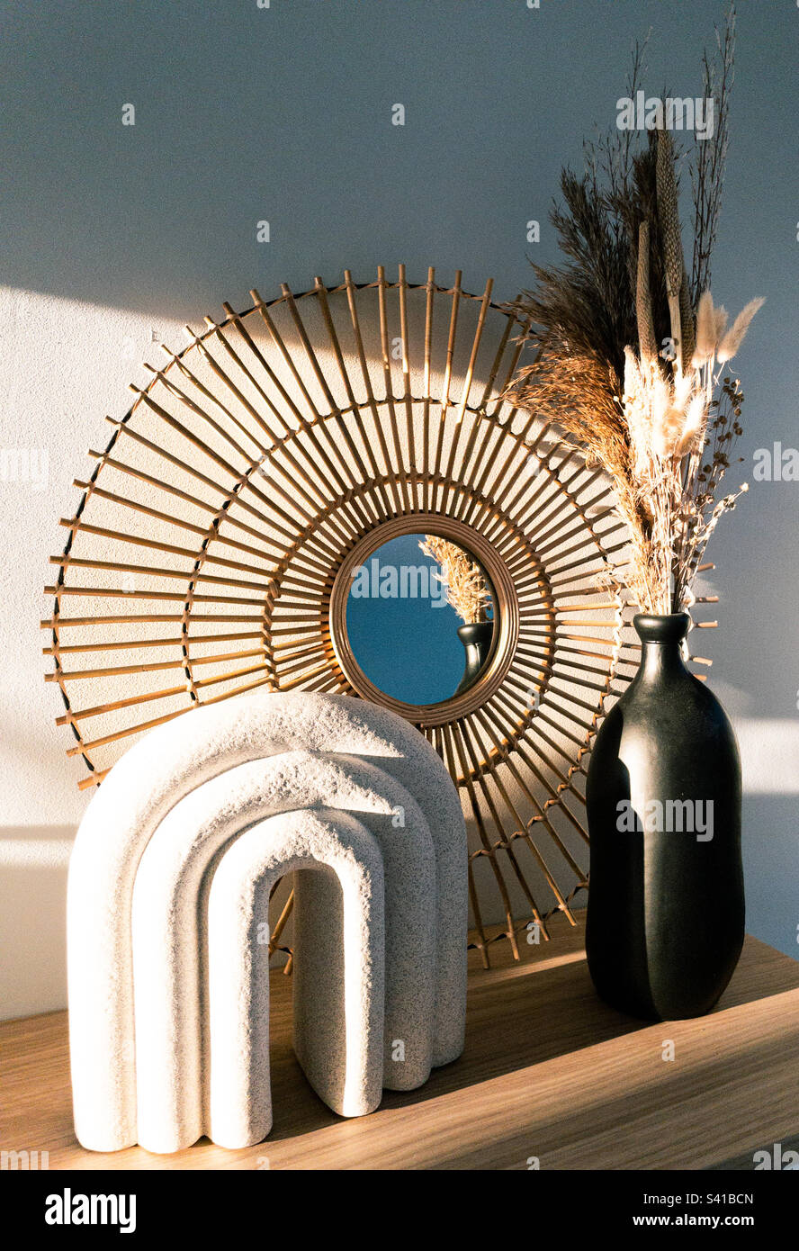 Specchio e fiori secchi in un fascio di luce solare Foto Stock