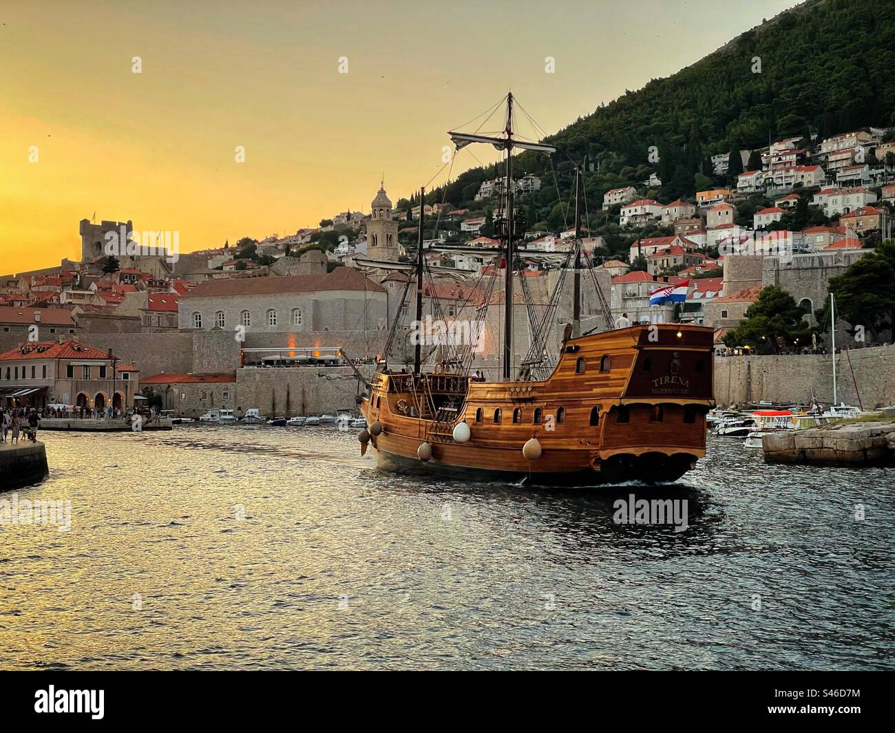Nave dei pirati in vecchio stile (Tirena) che esce dalla città vecchia di Dubrovnik al crepuscolo. - Immagine stock catturata con smartphone
