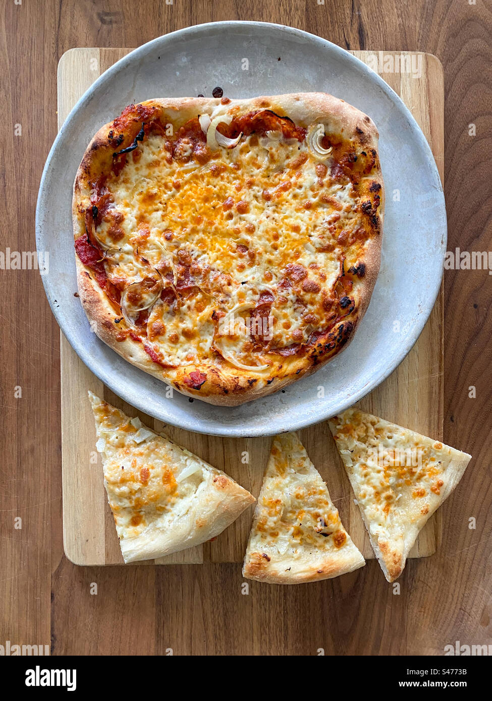 Pizza fatta in casa, una pizza completa e tre pezzi separati. Foto Stock