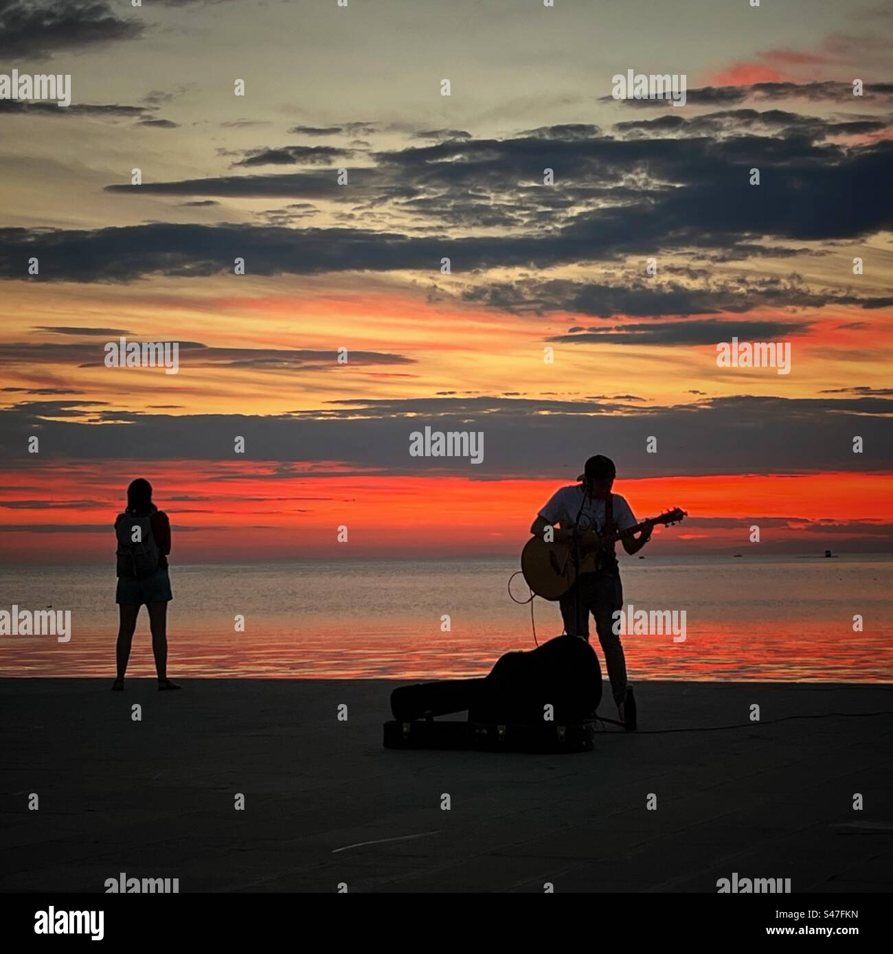 Silhouette di un chitarrista al tramonto - Immagine stock catturata con smartphone