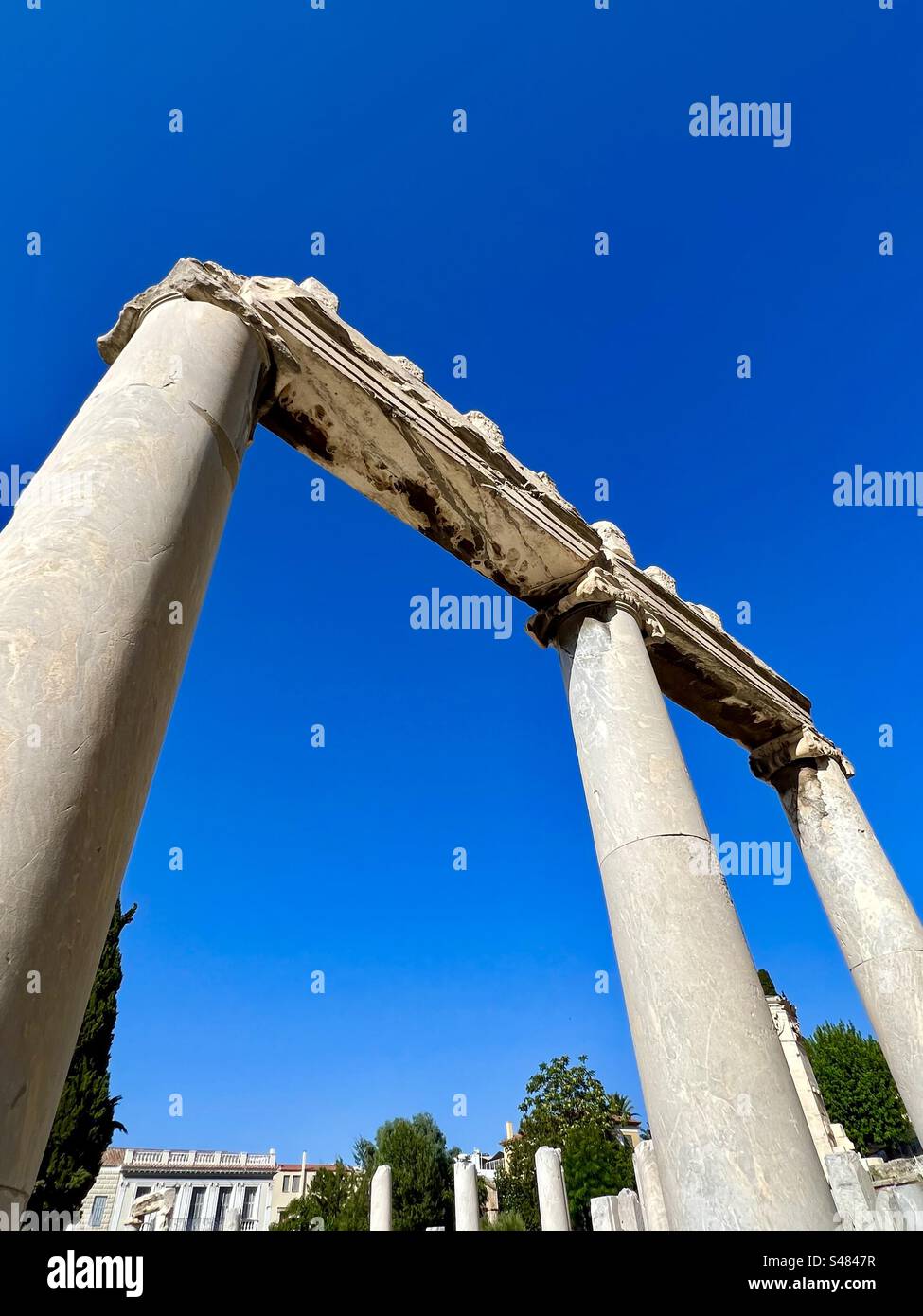 Antiche colonne su un cielo estivo blu brillante nel sito archeologico dell'Agorà romana ad Atene, Grecia Foto Stock