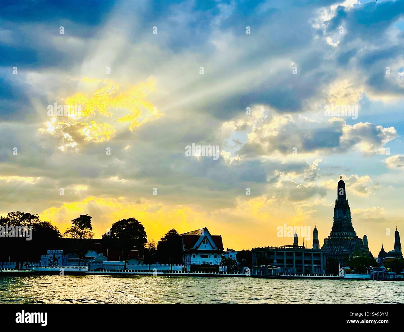 Un bellissimo tramonto sul fiume Chao Phraya e sul Wat Arun a Bangkok. Foto Stock