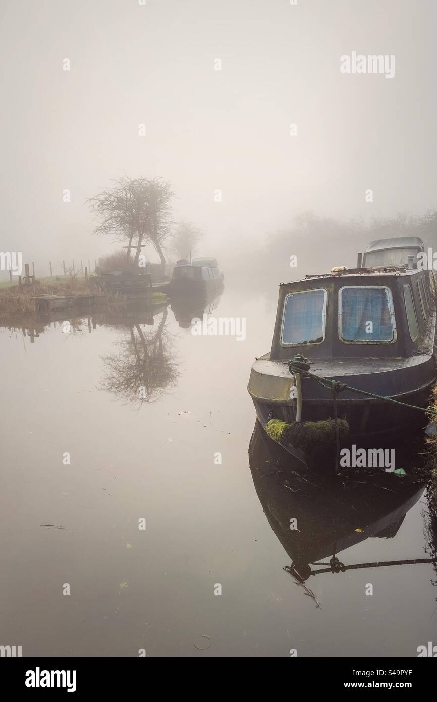 Barche strette ormeggiate in una mattinata nebbiosa sul canale di Leeds e Liverpool ad Adlington nel Lancashire Foto Stock