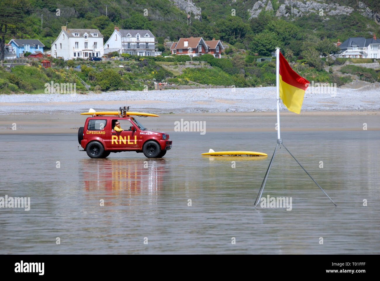 Bagnino RNLI in auto sulla spiaggia di Port Eynon Bay, Galles del Sud Foto Stock