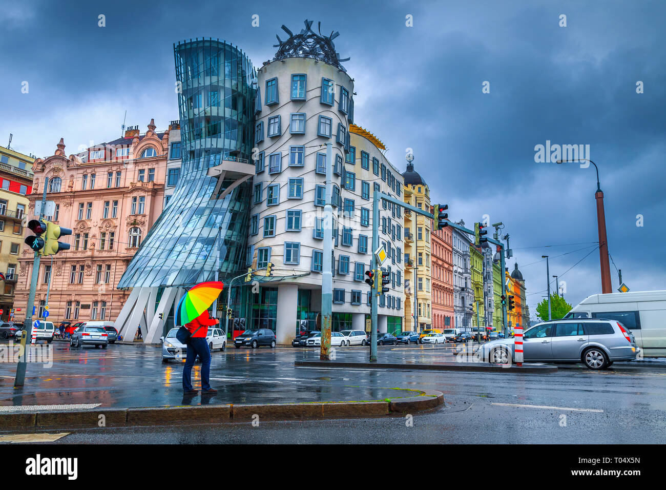 Tourist persone con rainbow ombrello colorato in un giorno di pioggia al bivio vicino la famosa casa Danzante, Praga, Repubblica Ceca, Europa Foto Stock