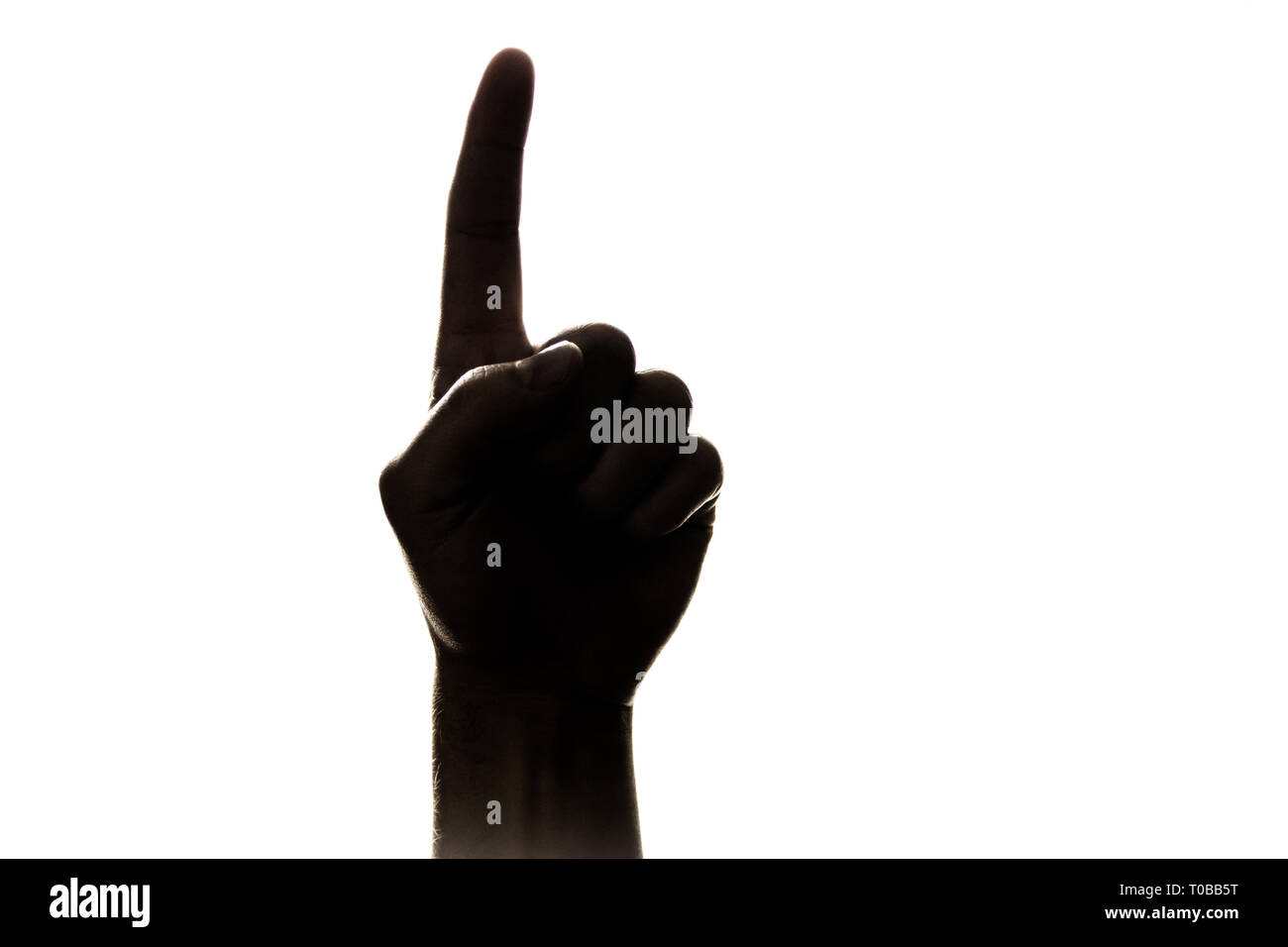 Silhouette nera di mano dando il "numero uno" segno con puntatore/indice; rivolta verso l'alto. Foto Stock