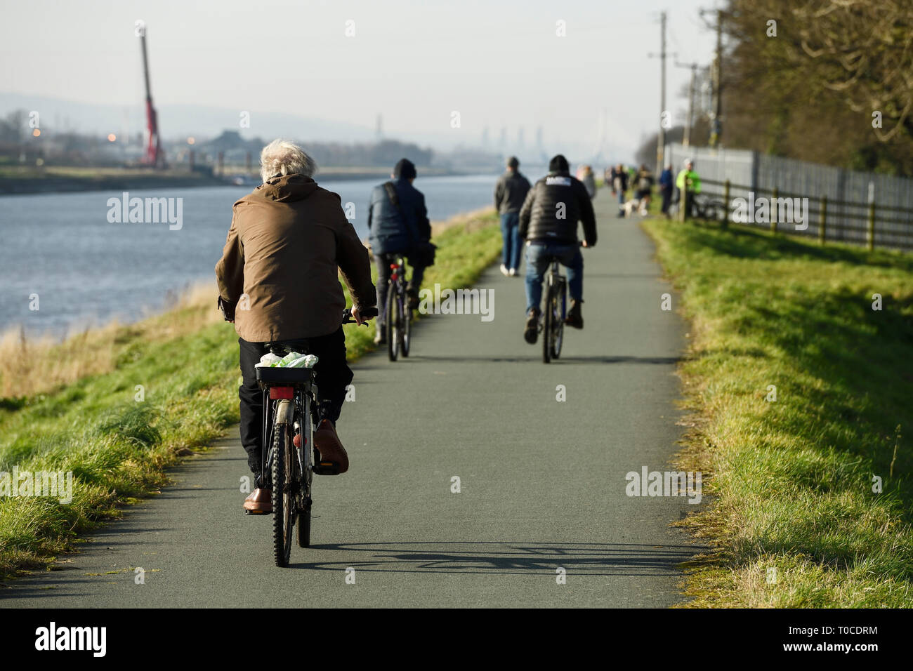 I ciclisti sul condiviso il ciclismo e il percorso pedonale lungo il fiume Dee a Ferry Lane voce fuori di Chester verso il Galles del Nord Regno Unito Foto Stock