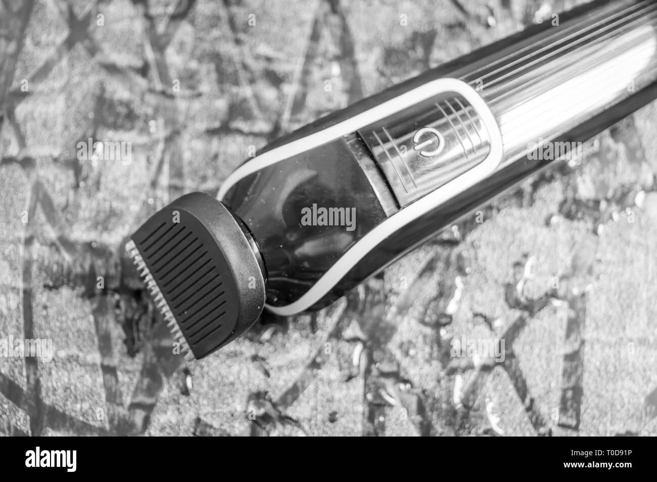 Uomo di rasatura elettrica della macchina. Trimmer mantenuto sul pavimento bagnato Foto Stock