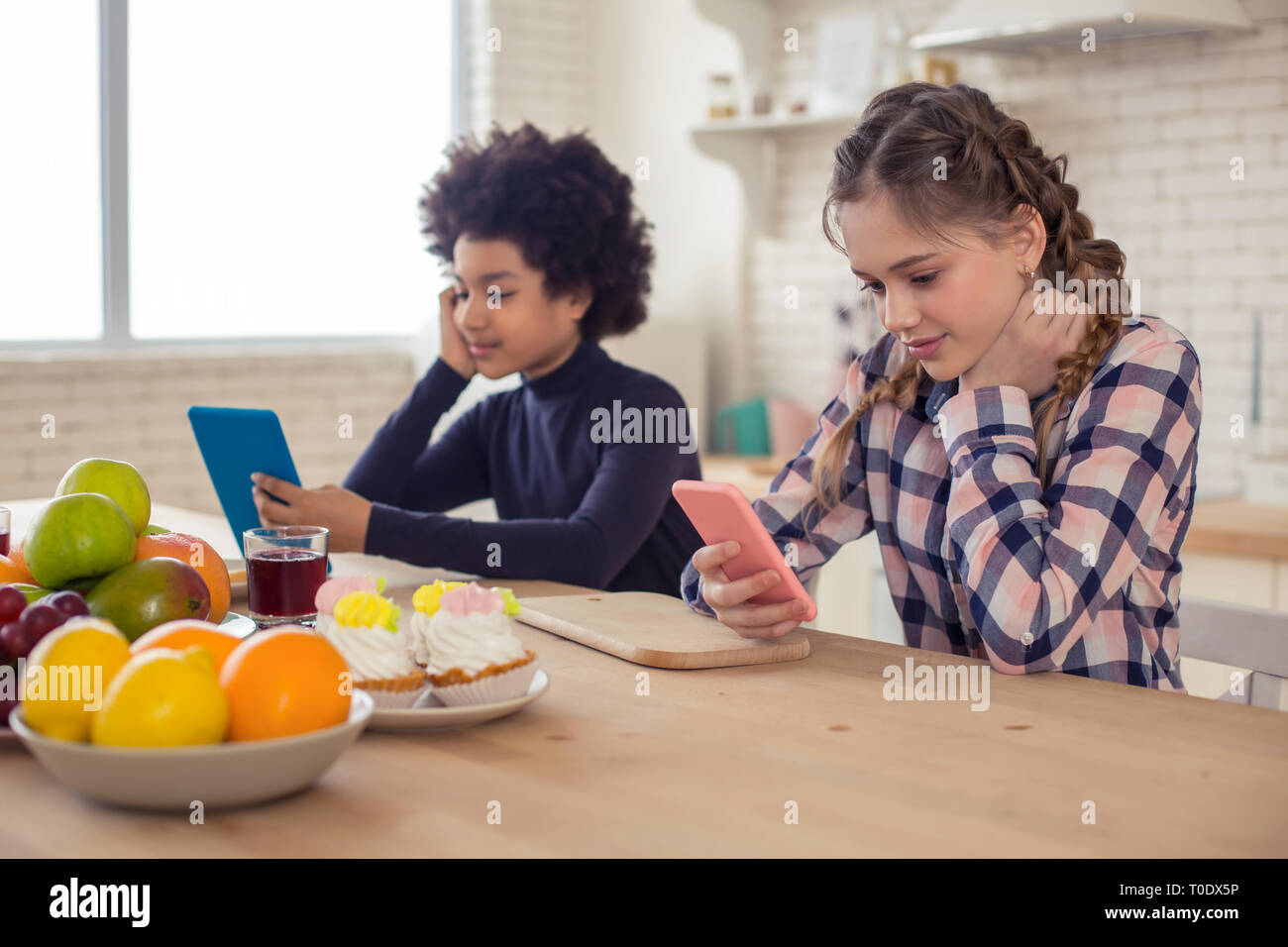 Positivo felici i bambini fissando la loro gadget Foto Stock