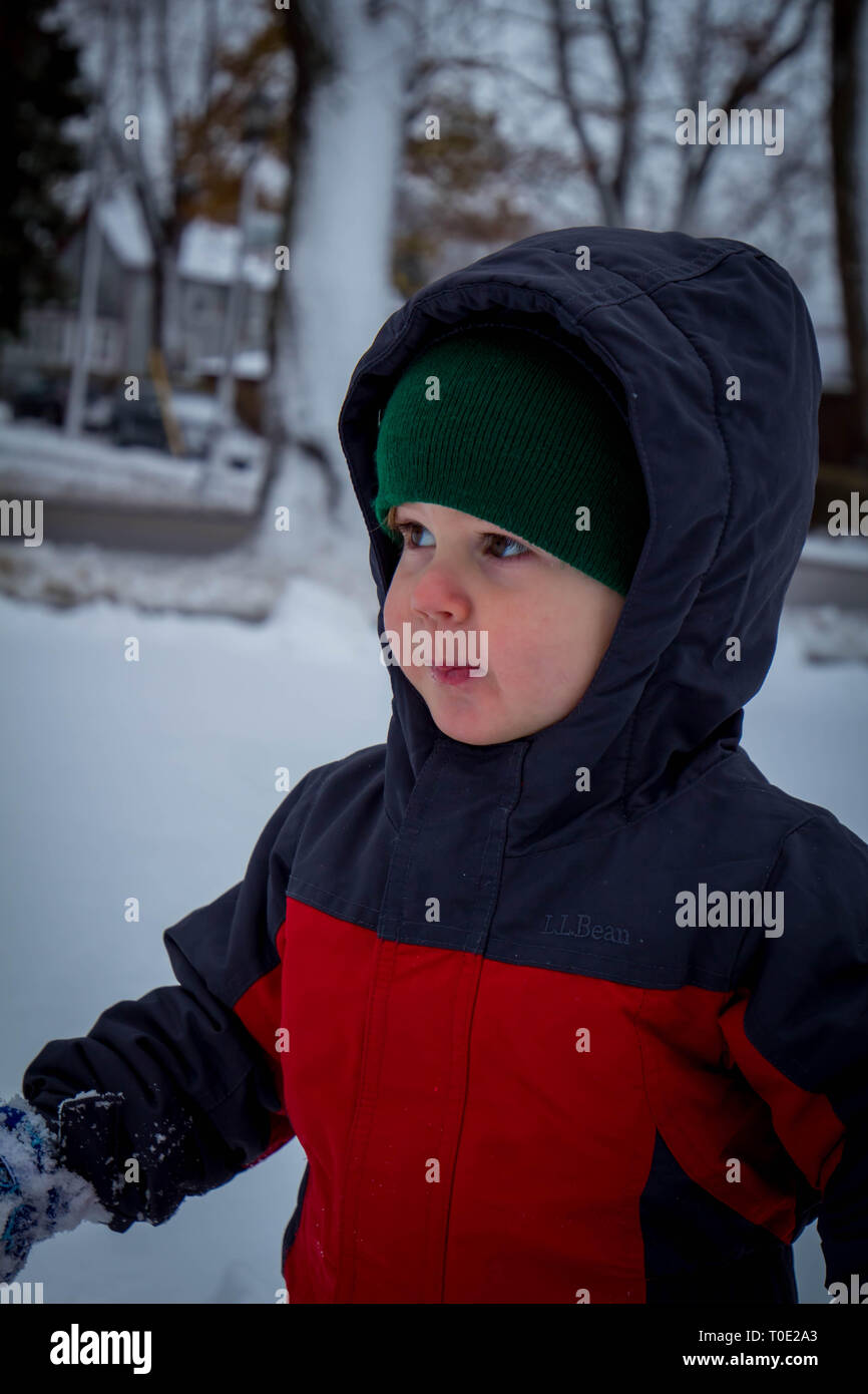 Bambino in tuta da neve godendo il primo giorno nevoso. Foto Stock
