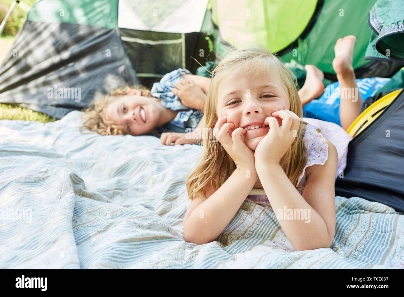 I fratelli figli poltrire insieme durante il campeggio durante le vacanze estive Foto Stock