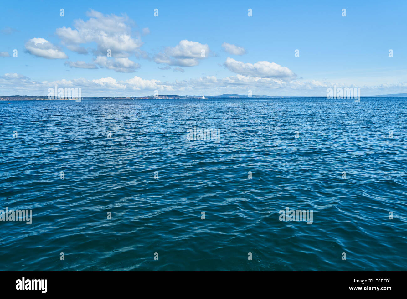 Dolci increspature su acqua dall'Oceano Atlantico davanti a un cielo blu Foto Stock