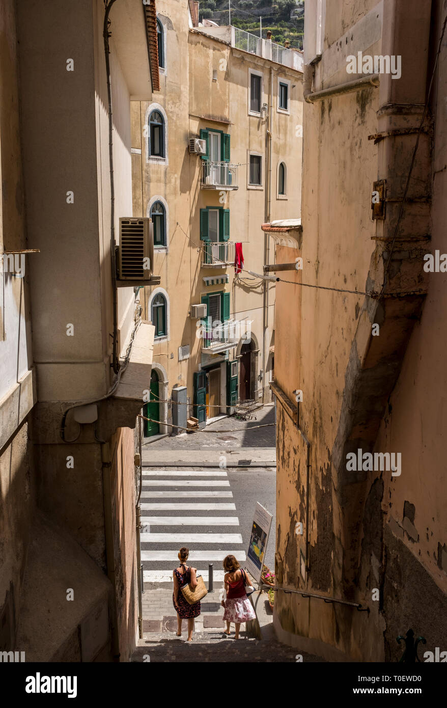 Due donne che scendono ripide scale per la strada a Minori, Italia sulla Costiera Amalfitana Foto Stock