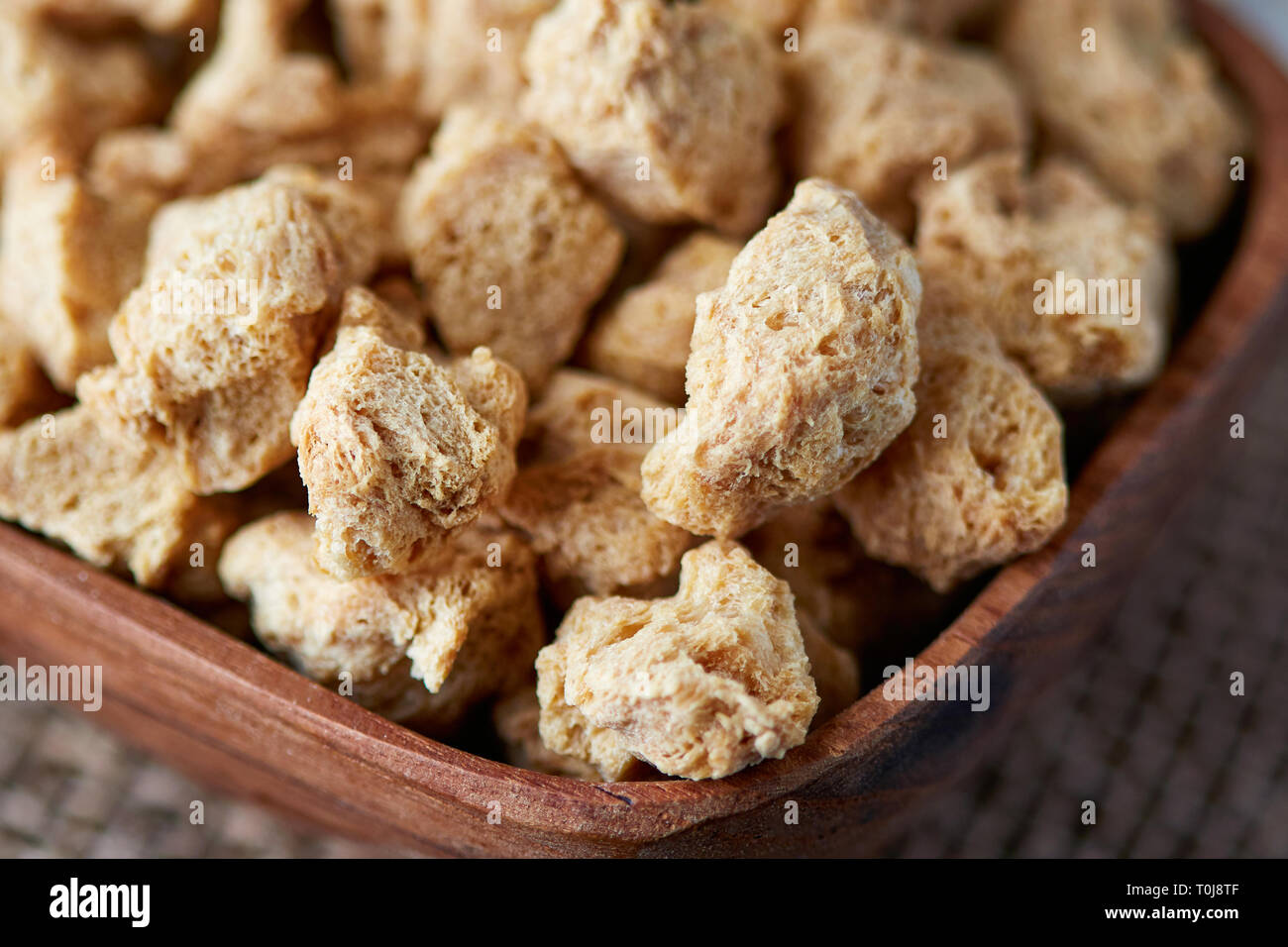 Raw bocconcini di soia, carne di soia per vegani nella ciotola di legno Foto Stock