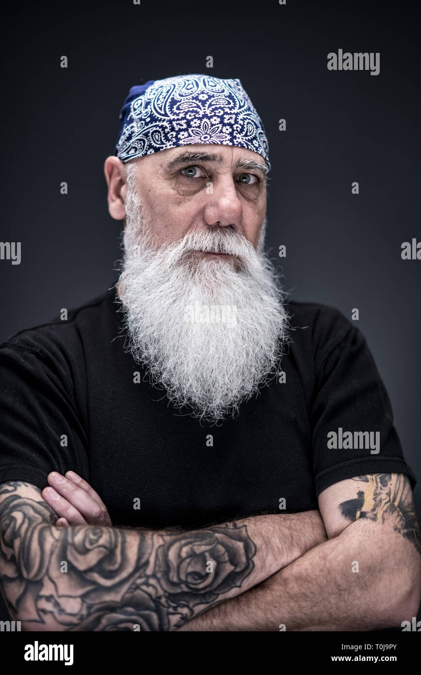 Ritratto in studio di un senior hipster con una lunga barba bianca Foto Stock